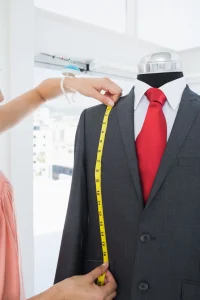 extreme-close-up-hands-measuring-suit-dummy